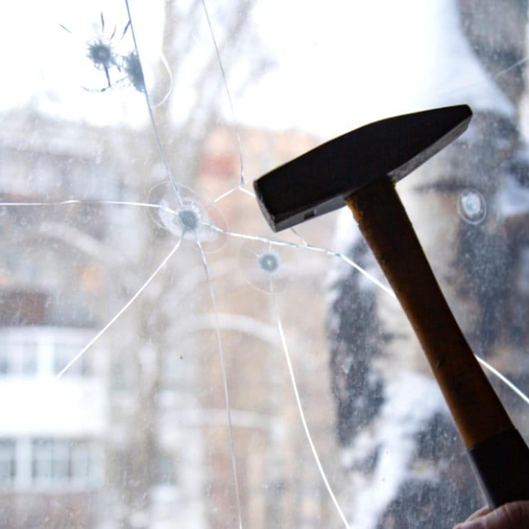 Cracked glass showcasing safety and security film protection from shattering.